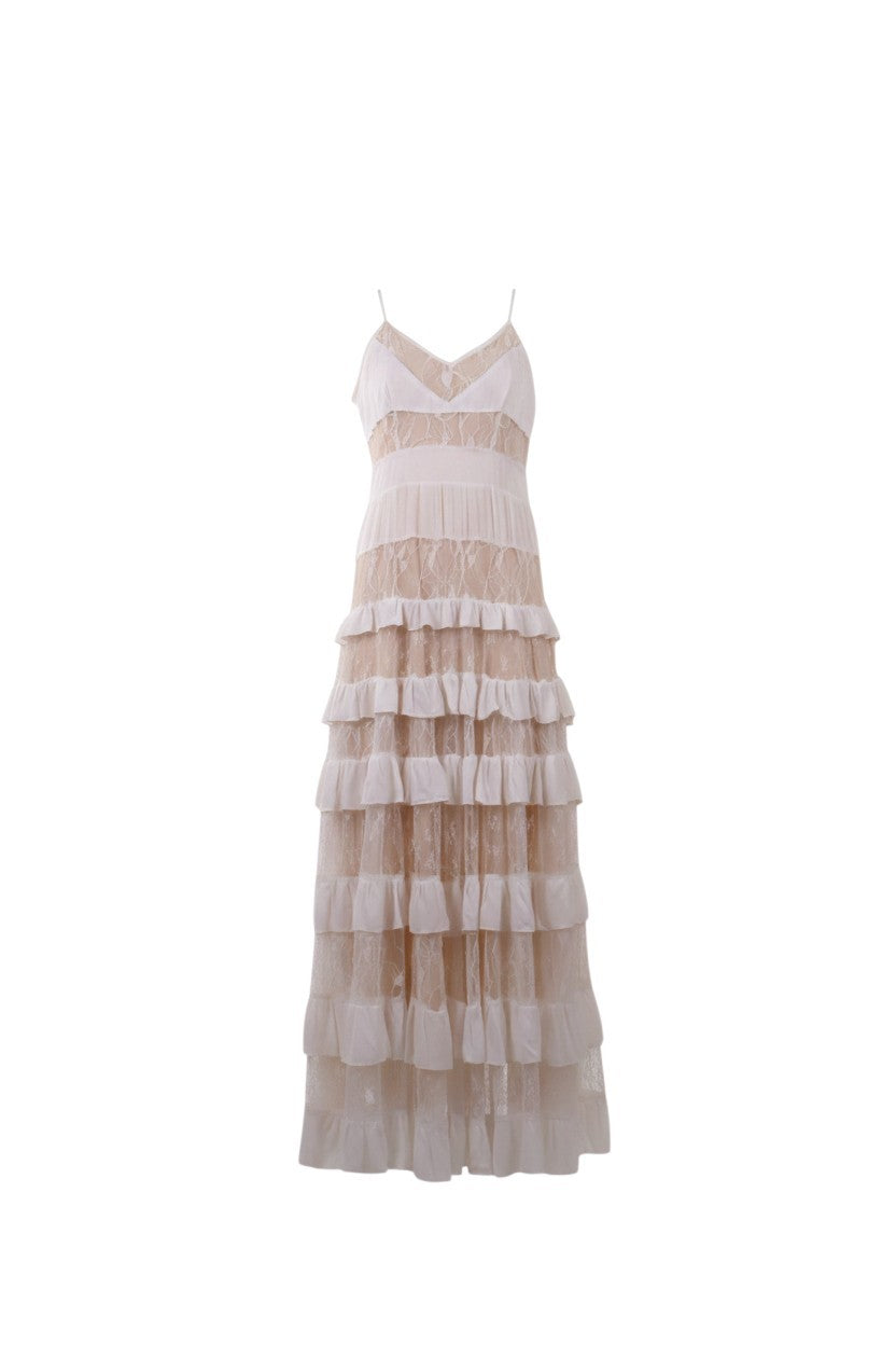 NAAMA ATHENS tiered lace maxi dress in neutral beige with V-neckline, spaghetti straps, and ruffled skirt panels.